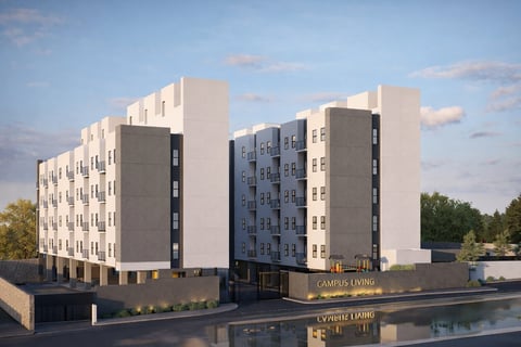 Fachada de edificio residencial moderno con fachadas blancas y azules junto a un canal bajo cielo azul