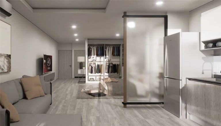 Interior de studio con sala, cocina integral y clóset de un departamento en Arïe Urban Living