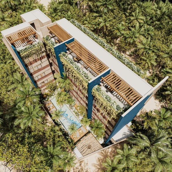 Aerial view of modern residential complex with blue-accented walls, wooden louvered roofs, and lush tropical vegetation surrounding it.