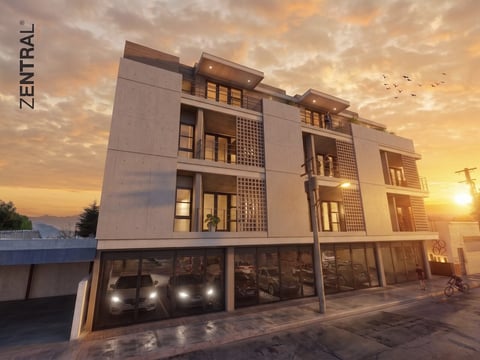 Modern residential building at sunset with illuminated windows and ground-level parking garage