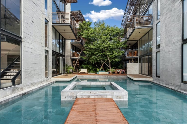 Courtyard with turquoise pool and white spa building