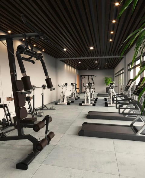 Gimnasio de London Cantera: gimnasio moderno con bicicletas estacionarias, caminadoras y equipo de ejercicio bajo techo negro con iluminación empotrada