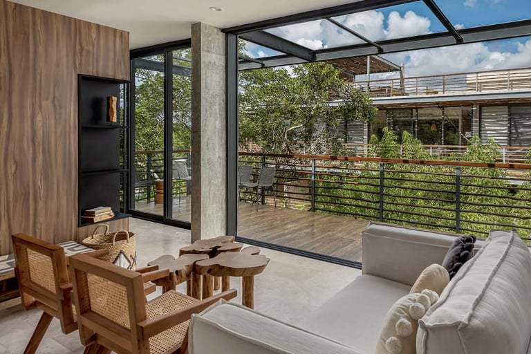 Living room with glass doors and skylight opening to deck