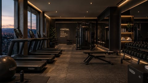 Modern luxury gym interior with treadmills, exercise equipment, and panoramic city views at dusk