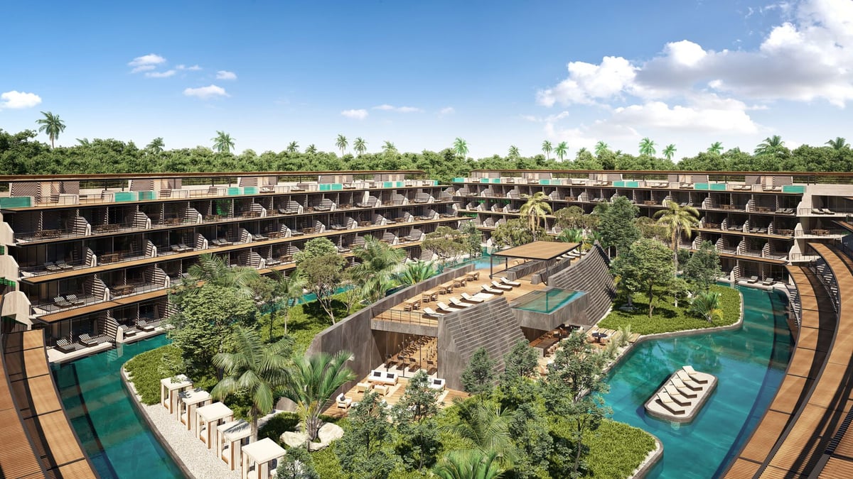 Aerial view of modern resort with curved buildings around central garden and pools