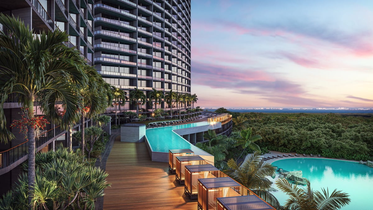 Modern high-rise resort with rooftop infinity pool at sunset