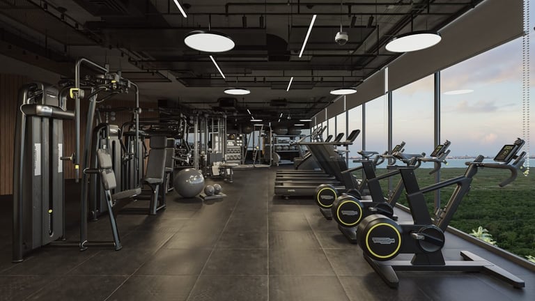 Modern gym with stationary bikes and large windows overlooking green landscape