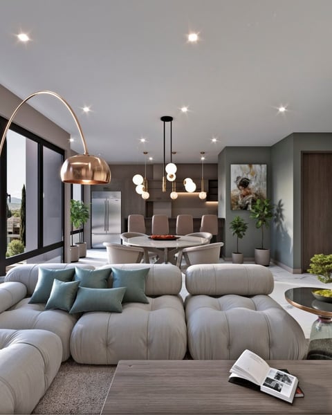 Modern living room with beige puffy sectional sofa, pendant lights, dining area, and contemporary furnishings in neutral tones