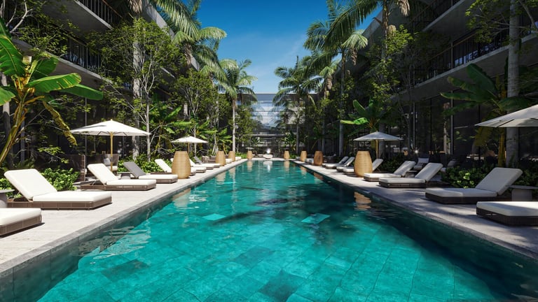 Luxury resort pool with loungers, umbrellas and palm trees flanked by modern buildings
